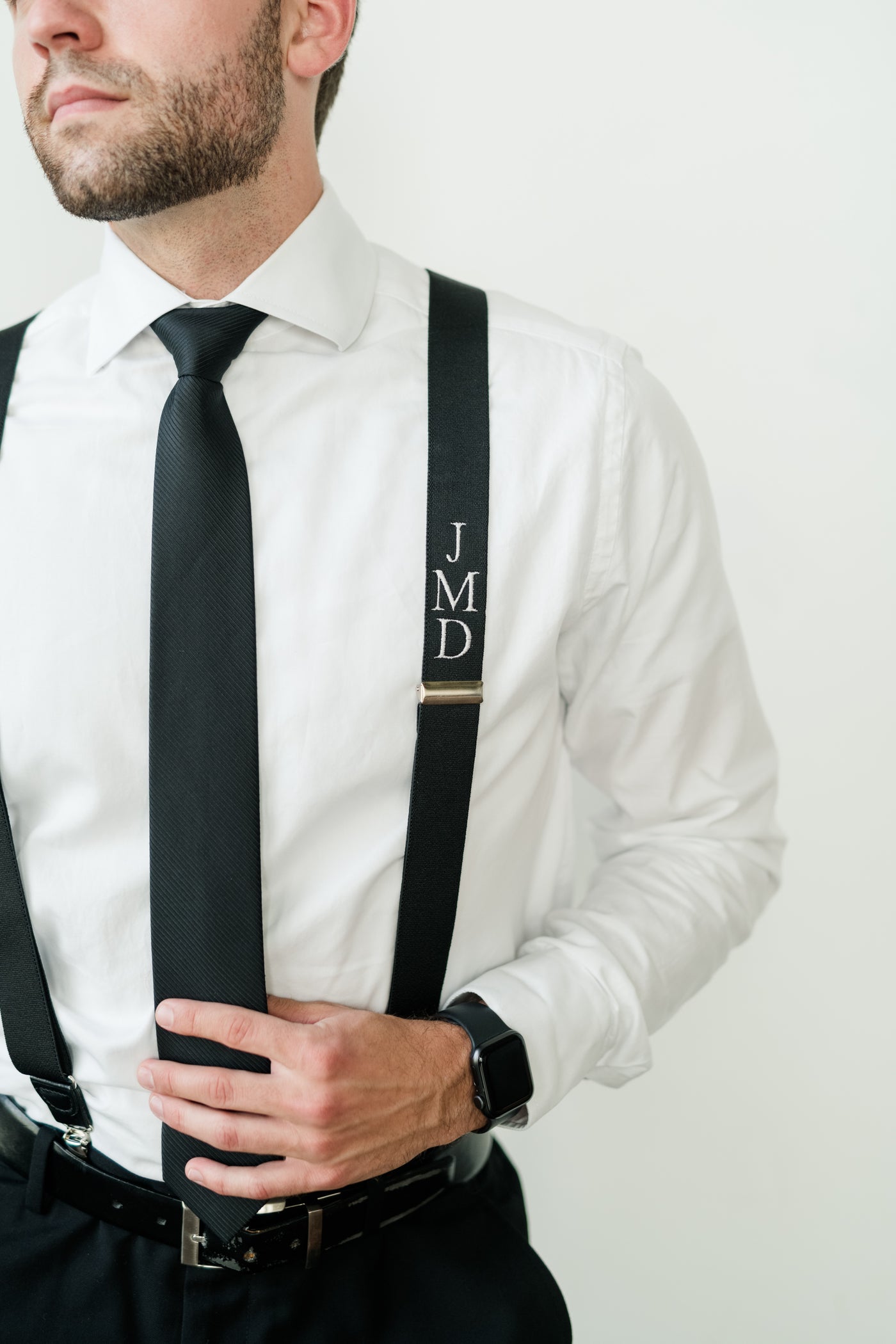 man wearing monogram suspender