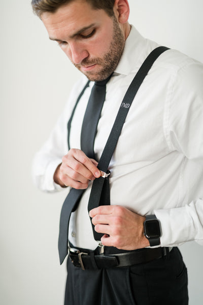man getting ready for black tie wedding