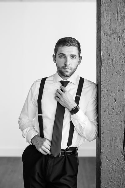 editorial image of groom wearing monogram suspenders for New York City wedding