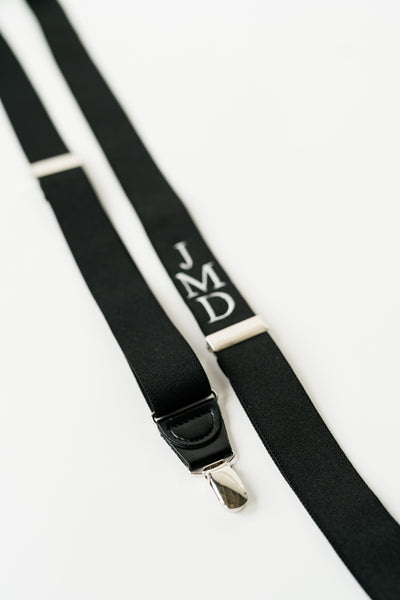 silver clip on suspender with white embroidered monogram