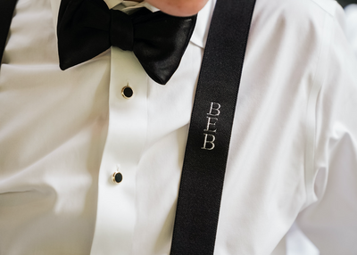 embroidered monogram suspender with black bow tie